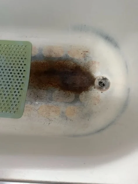 Rusty drain area before and after restoration