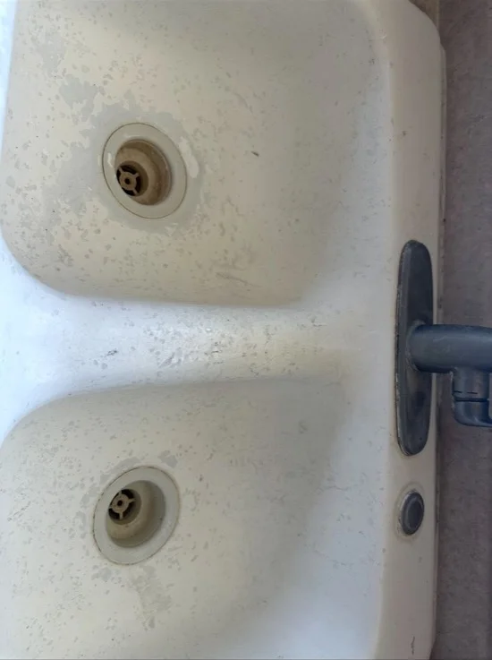 Worn bathtub surface refinished to high-gloss finish